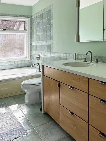 a bathroom with a sink toilet and shower