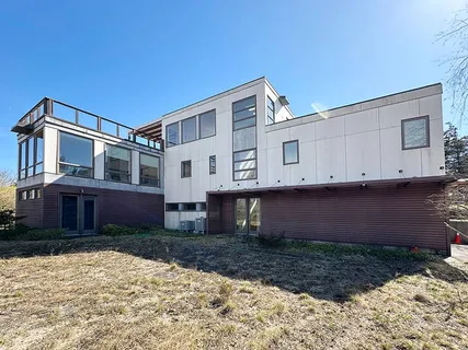 a view of a white house with a yard