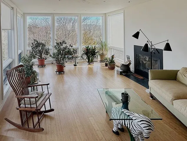 a living room with furniture and flowers