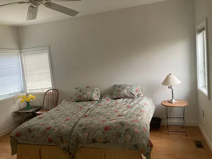 a bedroom with two bed and a lamp