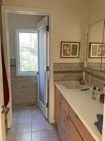 a bathroom with a sink a vanity and window