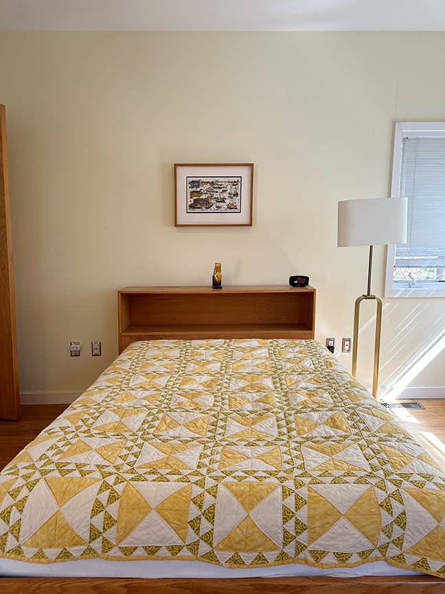 Undisclosed Address Water Mill, NY 11976 - Photo 9 of 12 a bed sitting in a bedroom next to a lamp