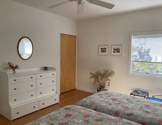 a bedroom with a bed and a dresser