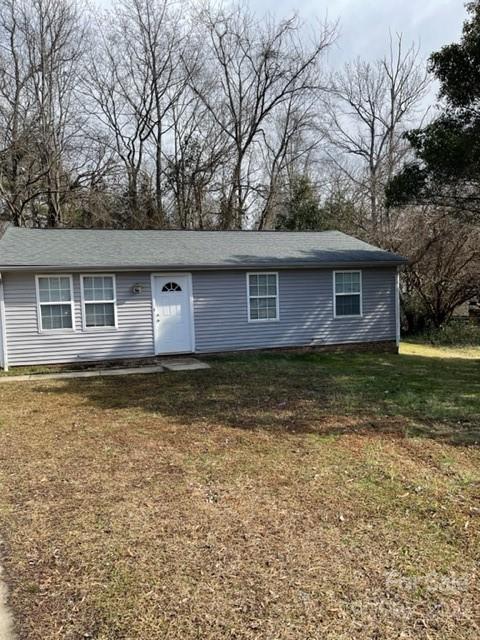 8129 Holly Hill Road Charlotte, NC 28227 - Photo 2 of 12 a front view of a house with garden