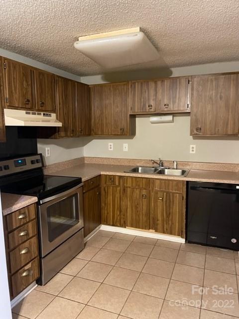 8129 Holly Hill Road Charlotte, NC 28227 - Photo 3 of 12 a kitchen with granite countertop a stove a sink and a microwave