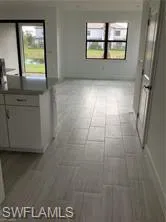 a view of a livingroom with an empty space and window