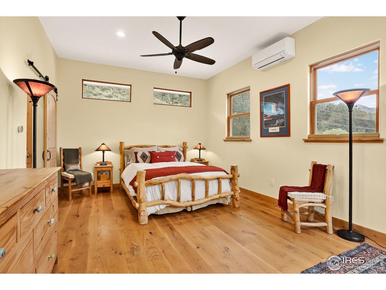 175 Main Street Jamestown, CO 80455 - Photo 14 of 44 a bedroom with a bed and a chandelier
