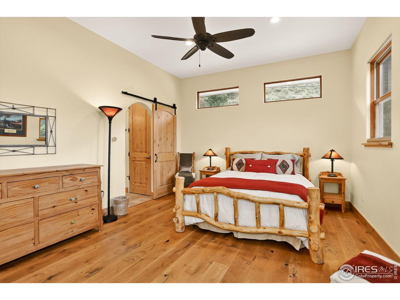 175 Main Street Jamestown, CO 80455 - Photo 18 of 44 a bedroom with a bed and a chandelier