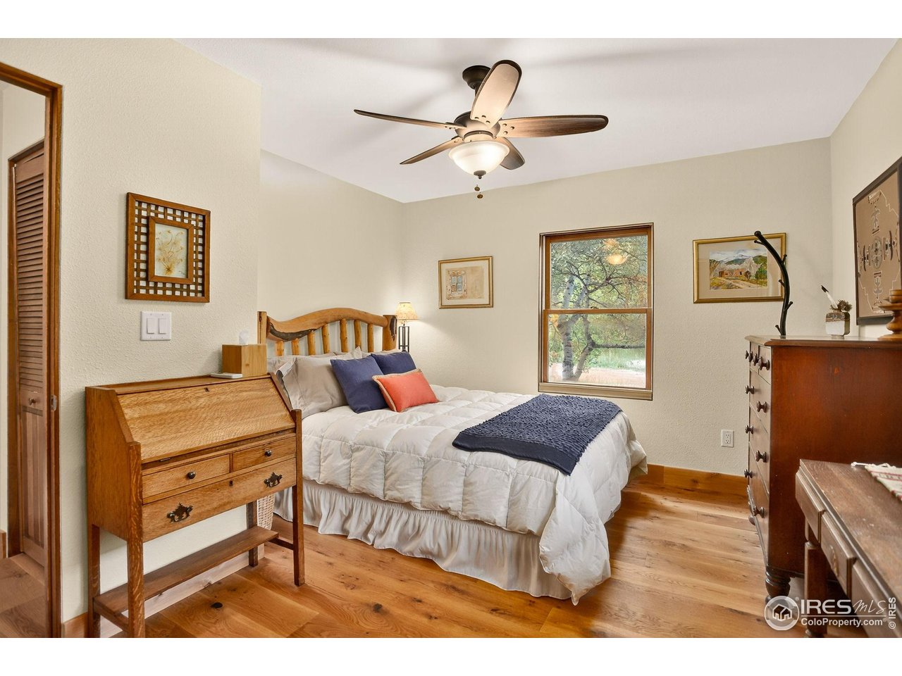 175 Main Street Jamestown, CO 80455 - Photo 22 of 44 a bedroom with a bed and wooden floor