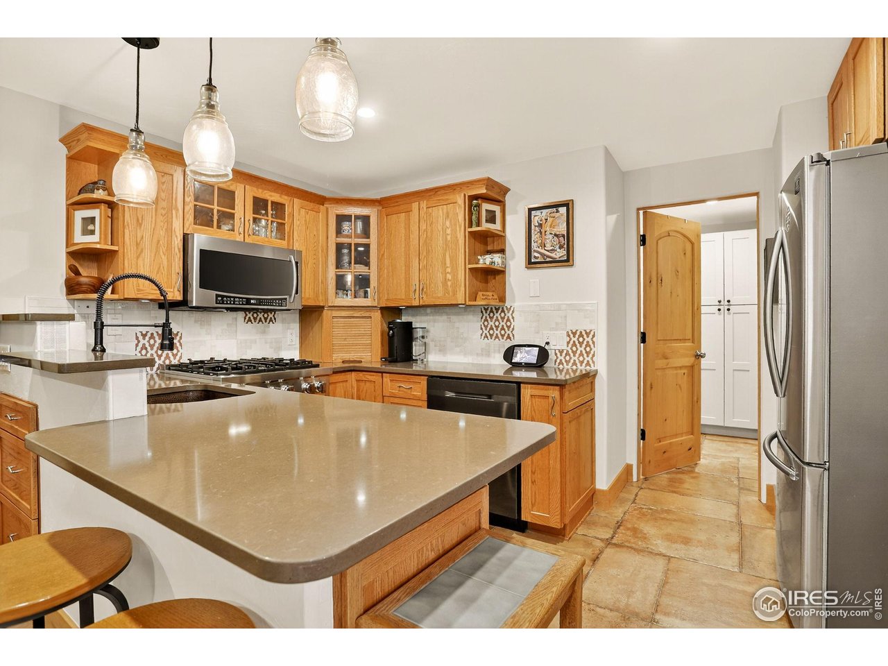 175 Main Street Jamestown, CO 80455 - Photo 28 of 44 a kitchen with stainless steel appliances granite countertop a sink refrigerator and cabinets