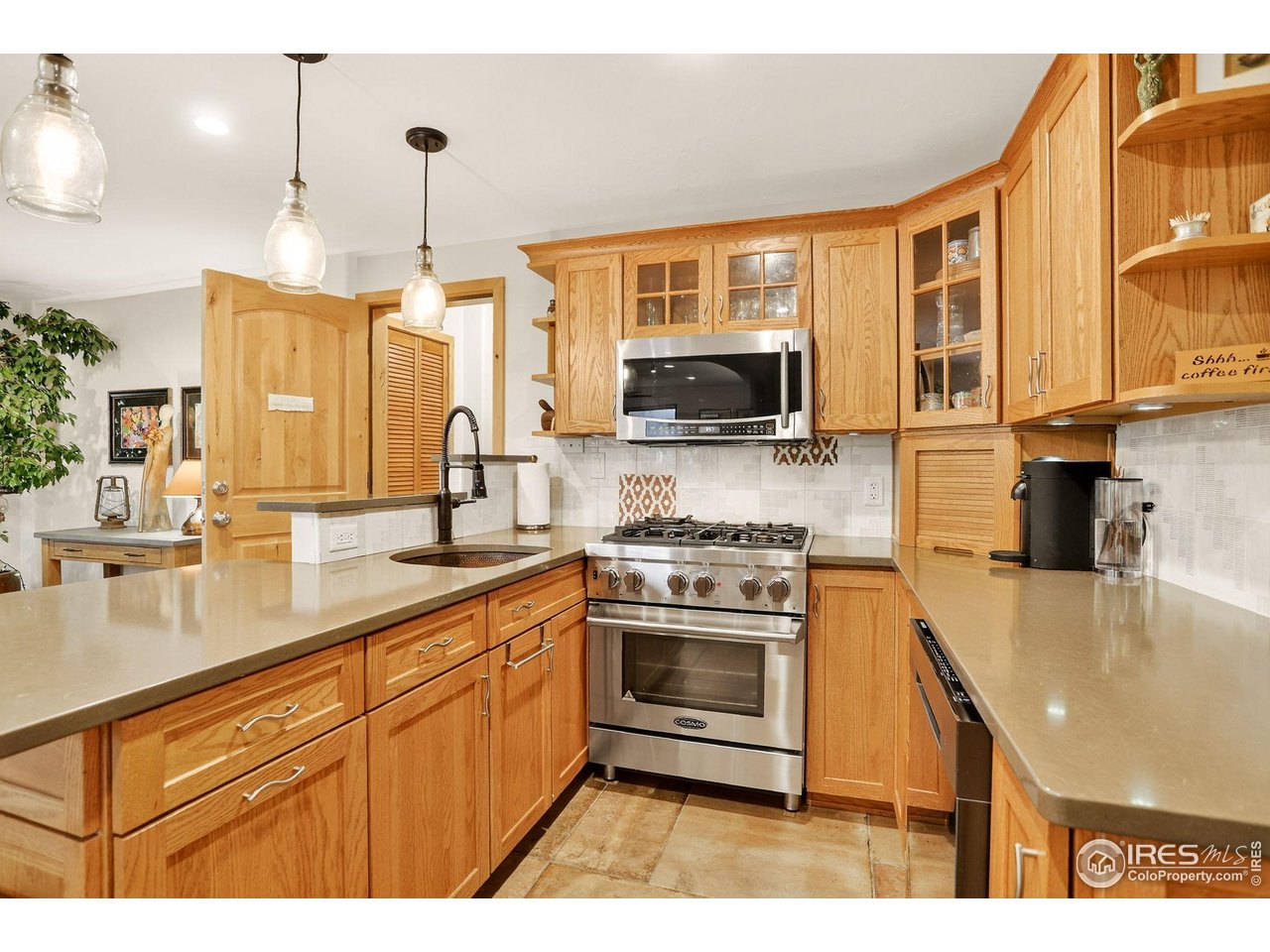 175 Main Street Jamestown, CO 80455 - Photo 29 of 44 a kitchen with stainless steel appliances granite countertop a sink a stove and a microwave
