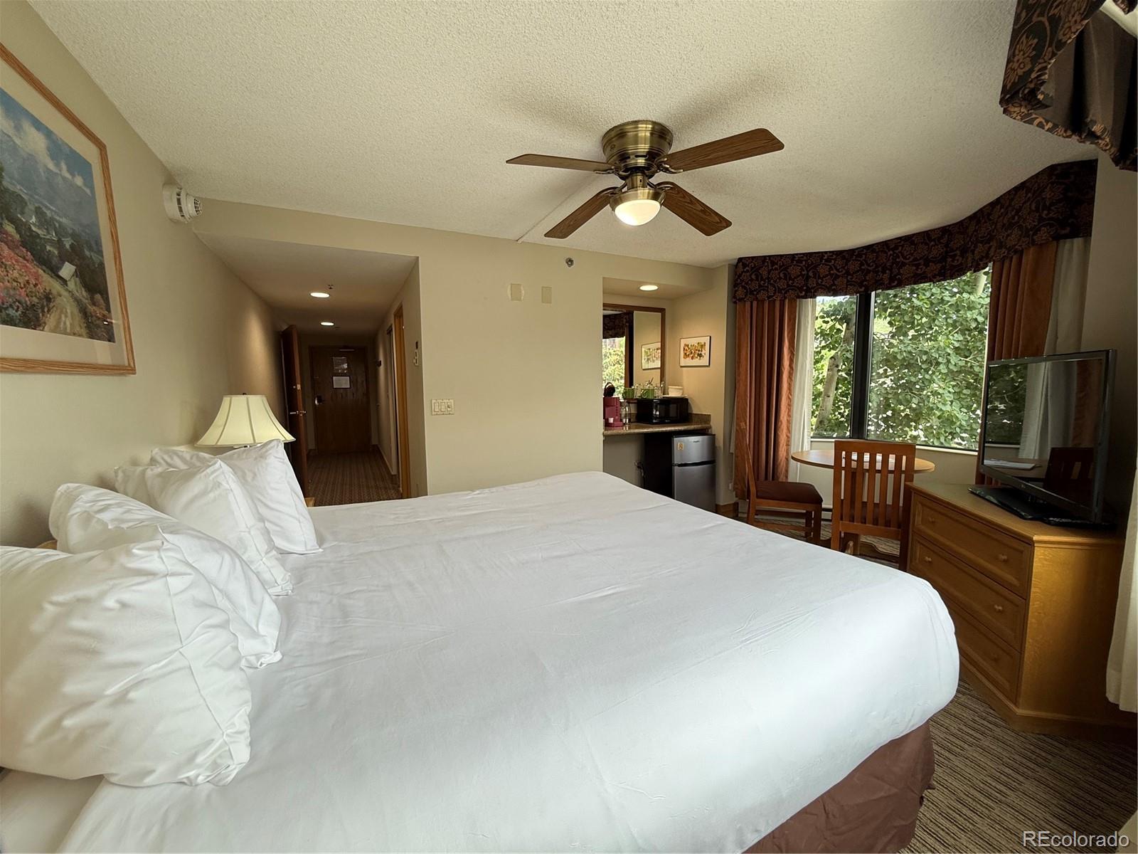 6 Emmons Road, Unit 379/381 Crested Butte, CO 81225 - Photo 1 of 34 a bedroom with a large bed and a chandelier