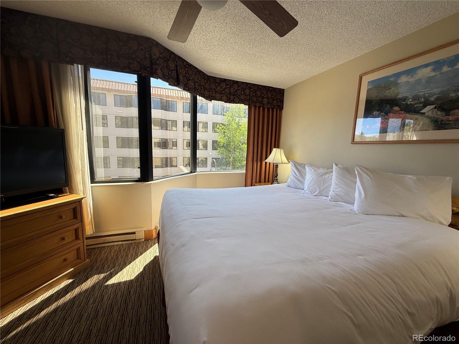 6 Emmons Road, Unit 379/381 Crested Butte, CO 81225 - Photo 19 of 34 a bedroom with a large bed and a large window