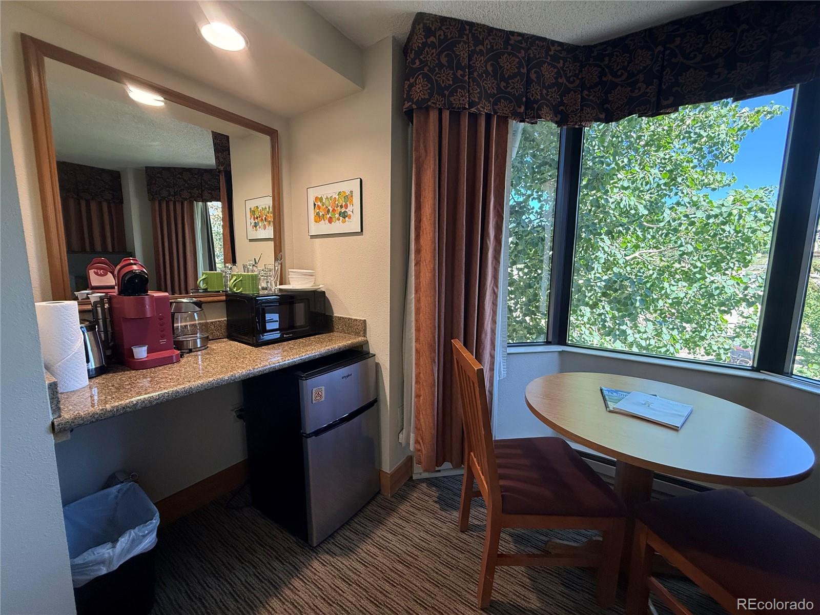 6 Emmons Road, Unit 379/381 Crested Butte, CO 81225 - Photo 20 of 34 a dining room with furniture and window
