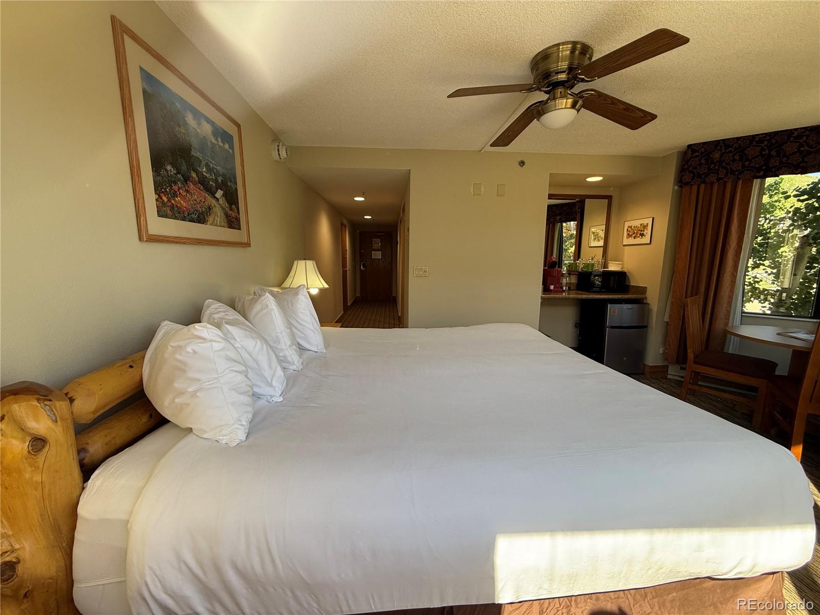 6 Emmons Road, Unit 379/381 Crested Butte, CO 81225 - Photo 22 of 34 a bedroom with a large bed and a chandelier