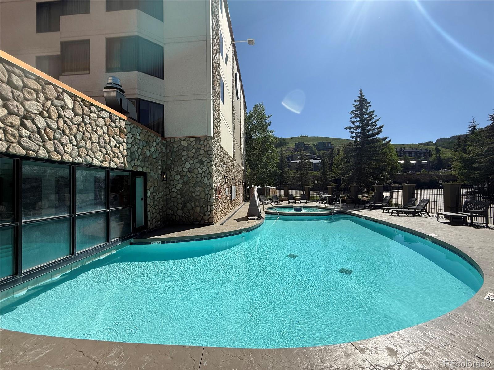 6 Emmons Road, Unit 379/381 Crested Butte, CO 81225 - Photo 4 of 34 a view of swimming pool with outdoor seating and yard in back