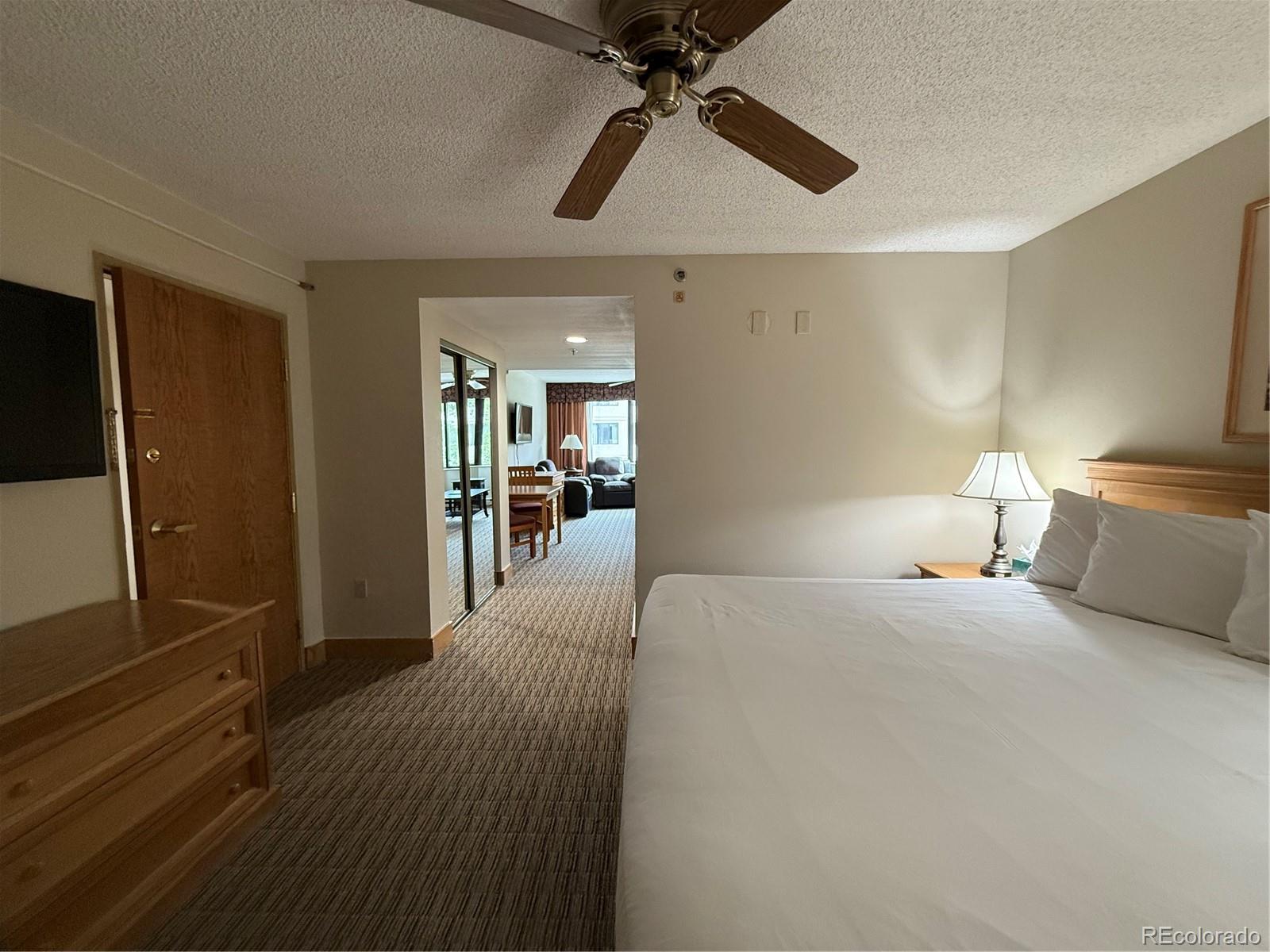 6 Emmons Road, Unit 379/381 Crested Butte, CO 81225 - Photo 8 of 34 a bedroom with a bed and a chandelier