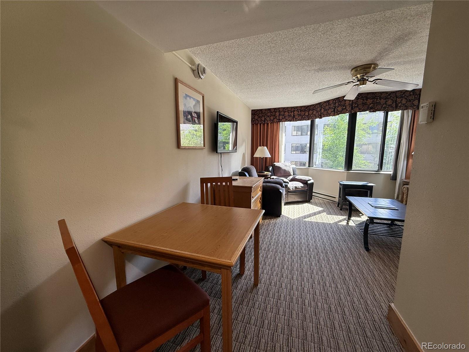 6 Emmons Road, Unit 379/381 Crested Butte, CO 81225 - Photo 10 of 34 a view of a dining room with furniture window and outside view