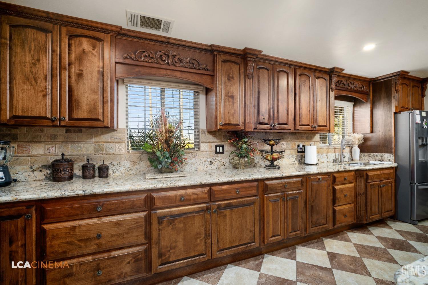Undisclosed Address Pixley, CA 93256 - Photo 17 of 45 a kitchen with stainless steel appliances granite countertop a sink and cabinets