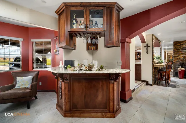a kitchen with stainless steel appliances granite countertop a sink a stove and a refrigerator