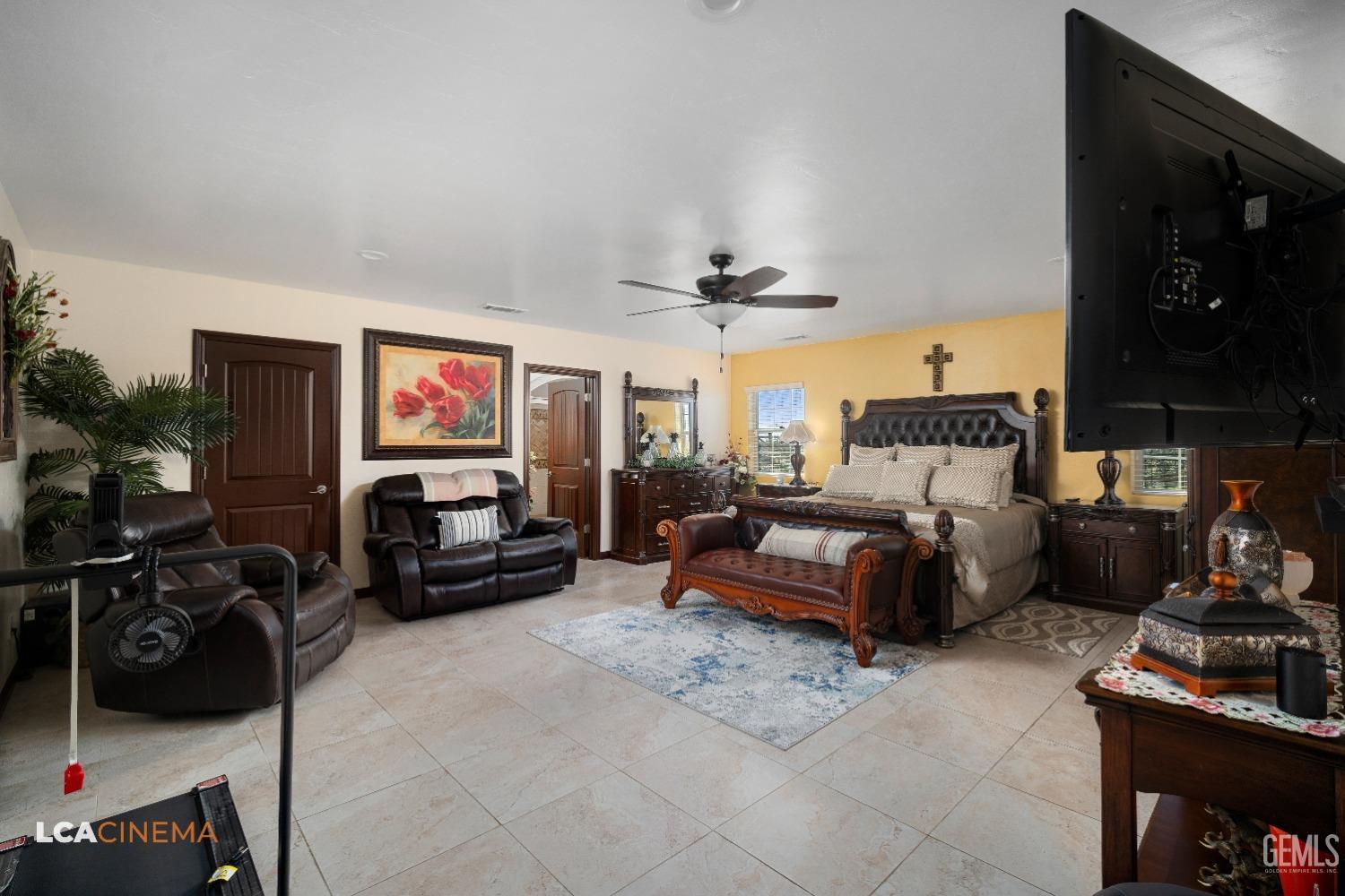 Undisclosed Address Pixley, CA 93256 - Photo 24 of 45 a bedroom with furniture a flat screen tv and gym equipment