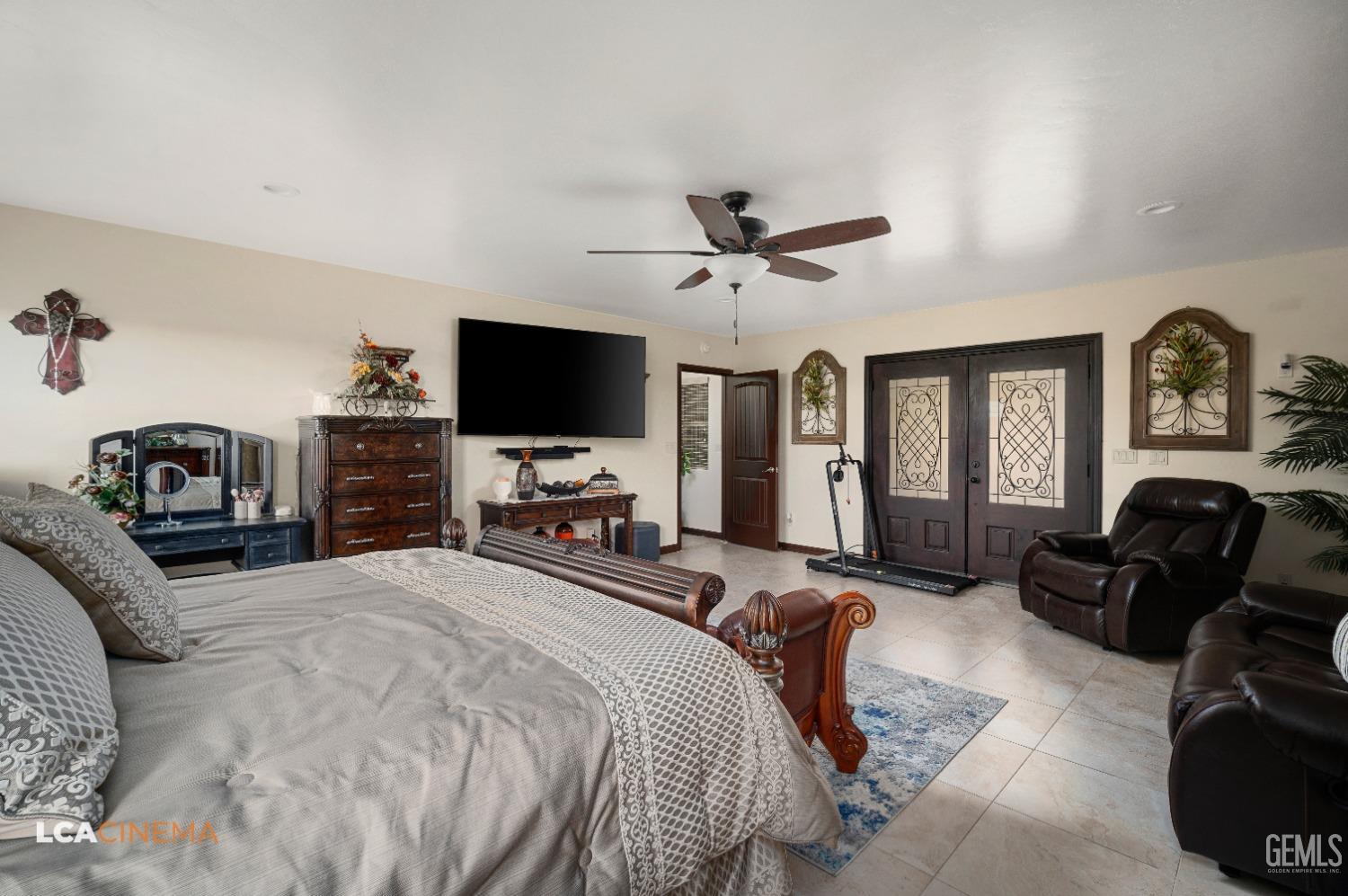 Undisclosed Address Pixley, CA 93256 - Photo 25 of 45 a bedroom with a bed a couch and a flat tv screen on the dresser