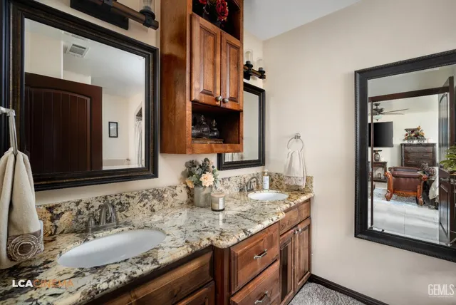 a view of a hallway with wooden floor and a bathroom
