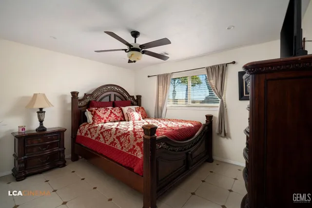 a bedroom with a bed and a television