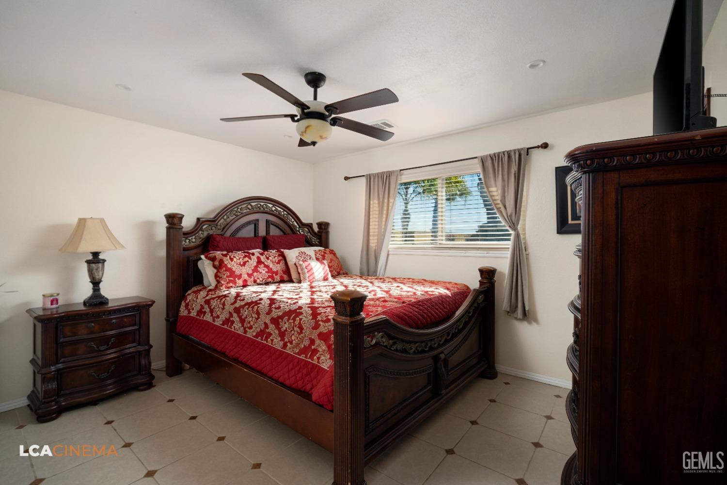 Undisclosed Address Pixley, CA 93256 - Photo 31 of 45 a bedroom with a bed and a window