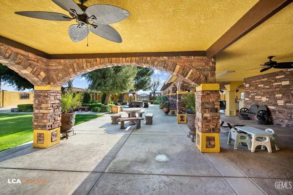 a view of a porch with dining table and chairs with a small yard