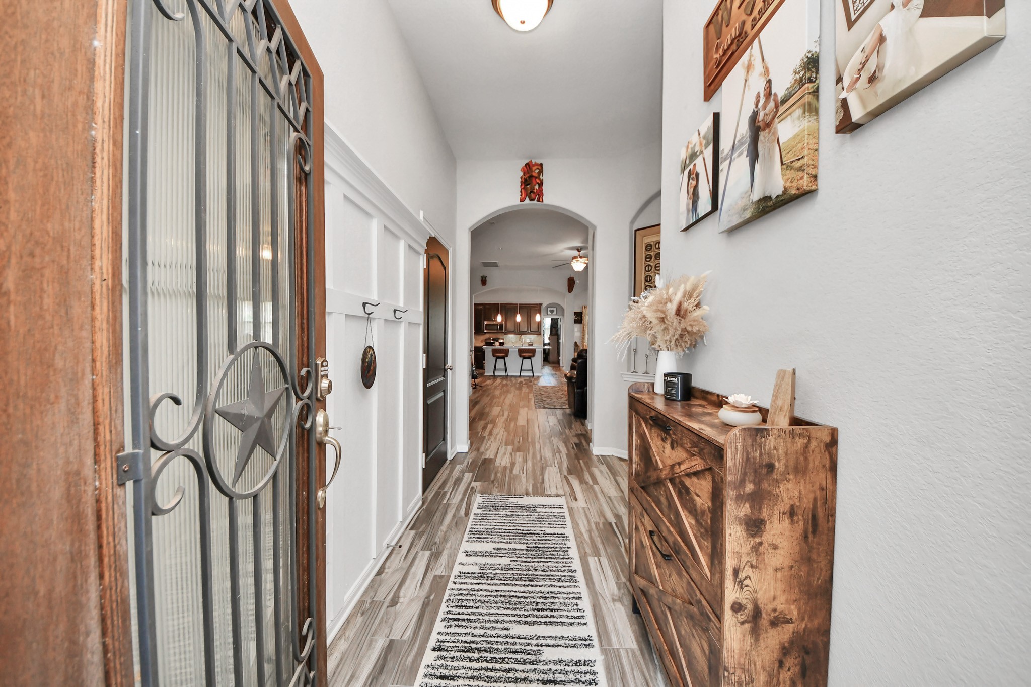 409 Billingsgate Chase, Unit CHASE Conroe, TX 77304 - Photo 4 of 45 This inviting entryway features a stylish wooden door with decorative ironwork, leading to family room