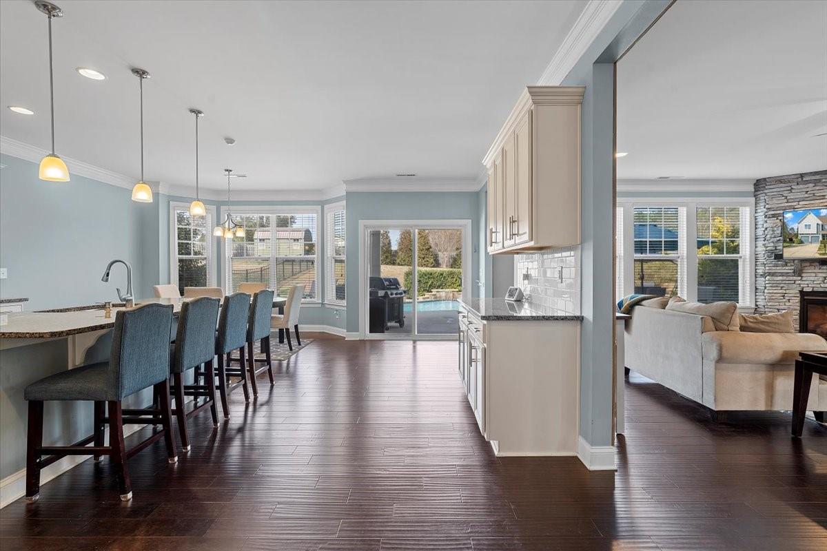 7399 Albemarle Drive Denver, NC 28037 - Photo 15 of 48 a view of a dining room and livingroom with furniture wooden floor kitchen view and a chandelier
