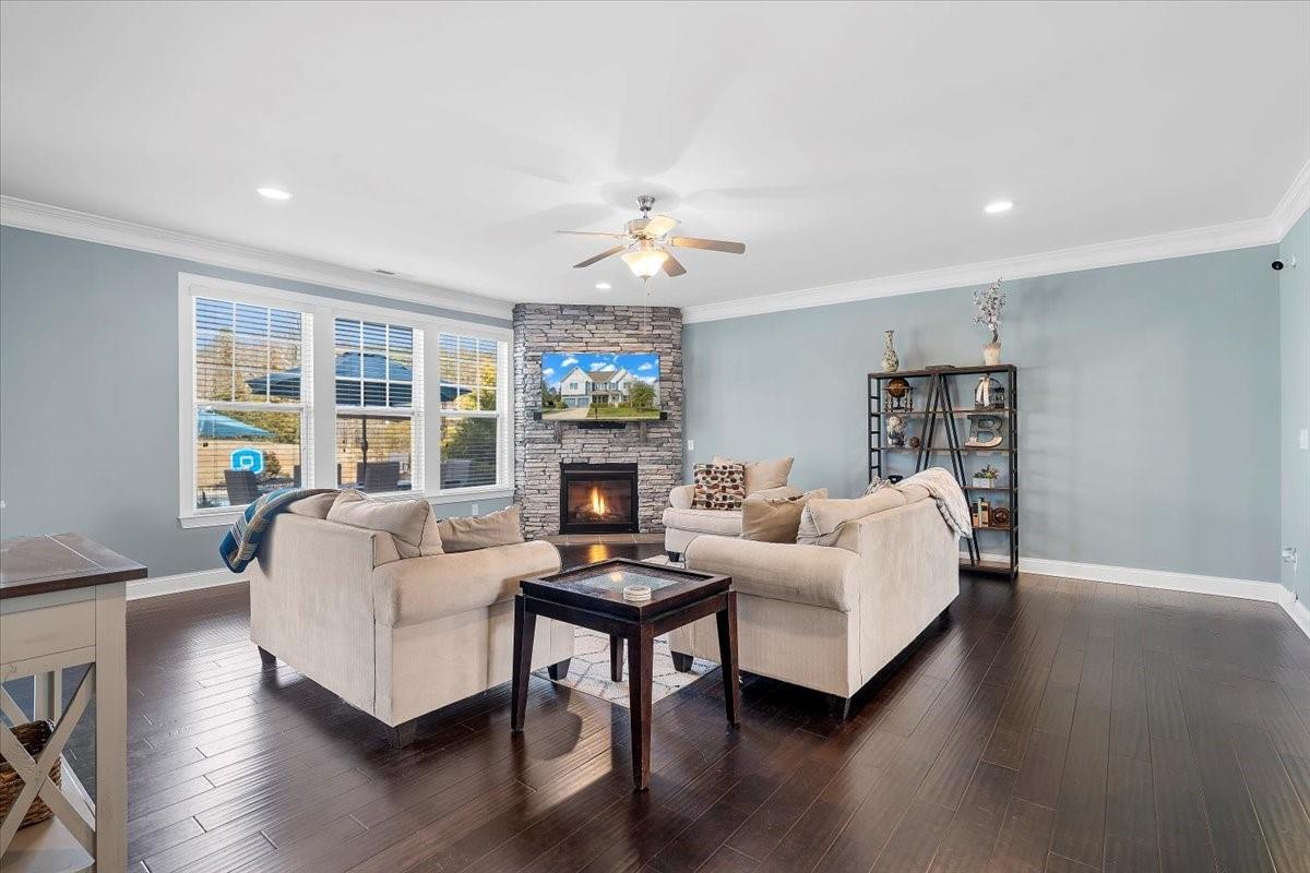 7399 Albemarle Drive Denver, NC 28037 - Photo 16 of 48 a living room with furniture a fireplace and a chandelier