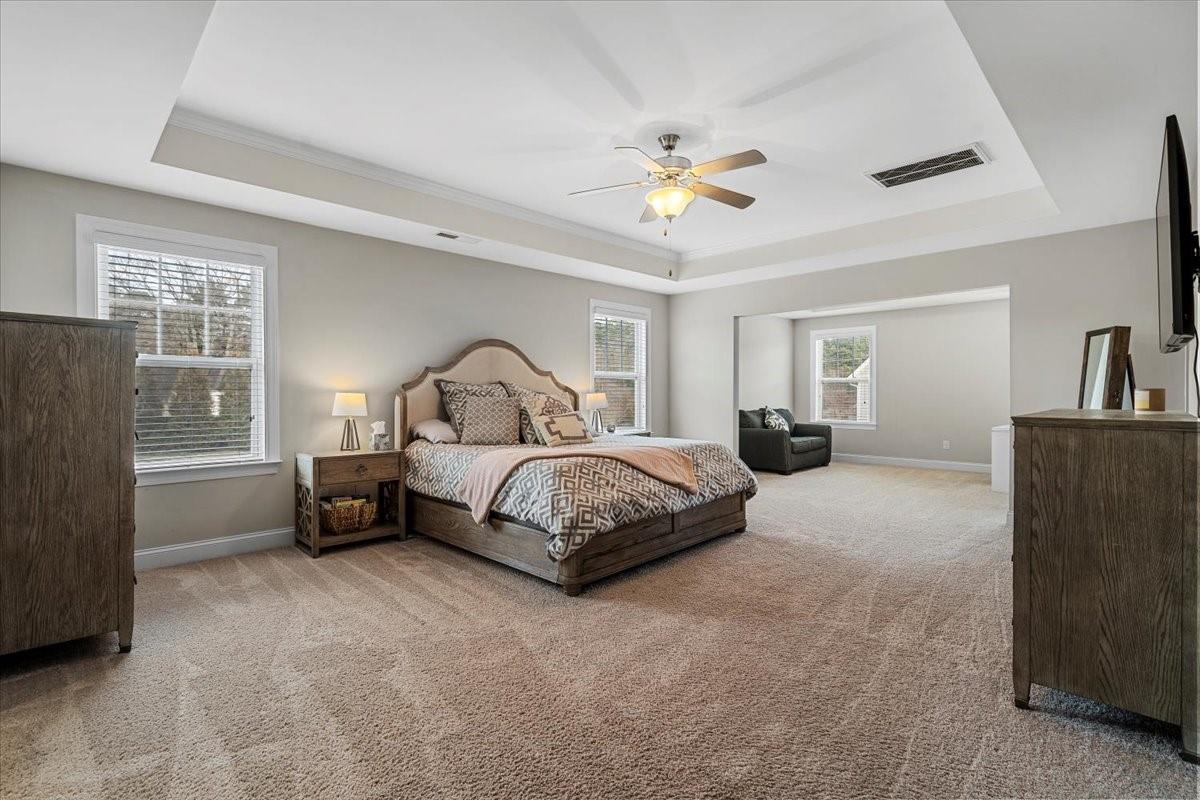 7399 Albemarle Drive Denver, NC 28037 - Photo 24 of 48 a bedroom with a bed and a chandelier