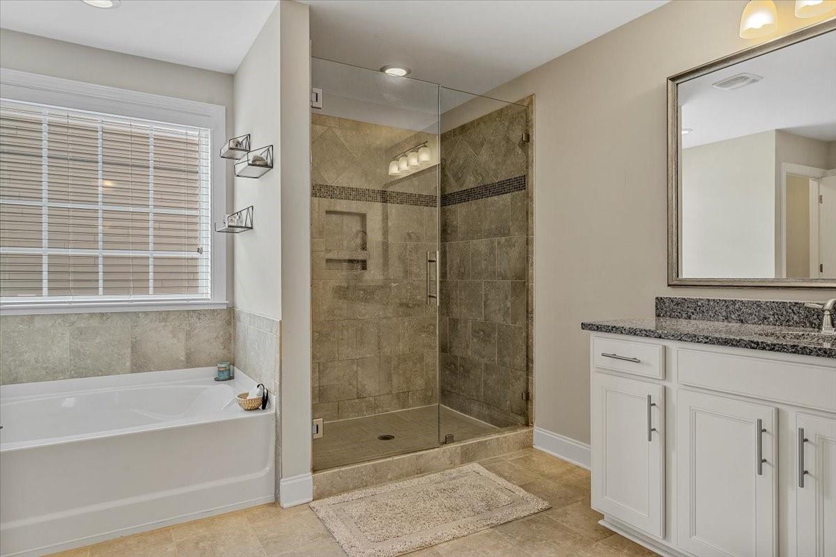 7399 Albemarle Drive Denver, NC 28037 - Photo 29 of 48 a bathroom with a granite countertop sink a mirror bathtub and shower