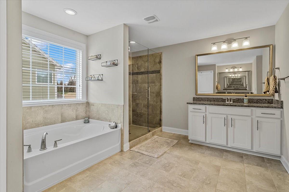7399 Albemarle Drive Denver, NC 28037 - Photo 31 of 48 a spacious bathroom with a tub sink and mirror