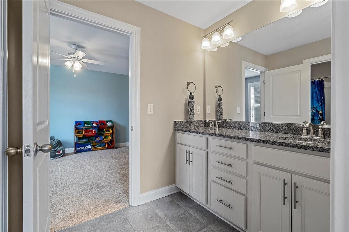 7399 Albemarle Drive Denver, NC 28037 - Photo 33 of 48 a bathroom with a double vanity sink and a mirror