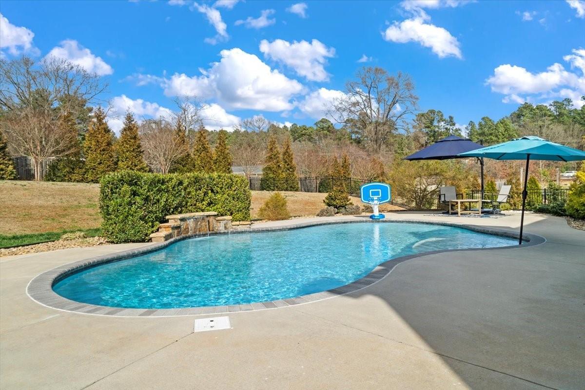 7399 Albemarle Drive Denver, NC 28037 - Photo 42 of 48 a view of a swimming pool with an outdoor seating and a yard