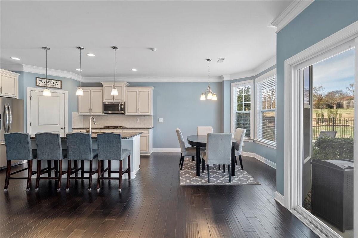 7399 Albemarle Drive Denver, NC 28037 - Photo 10 of 48 a view of a dining room with furniture and wooden floor