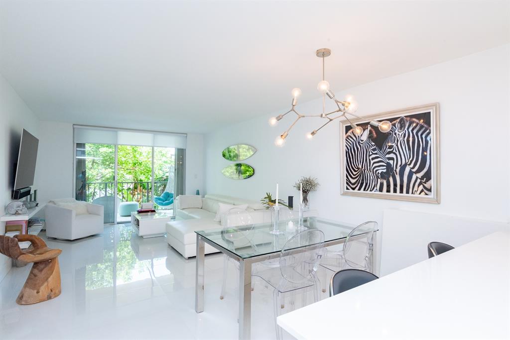 3581 South Ocean Boulevard, Unit 2B Palm Beach, FL 33480 - Photo 12 of 41 a dining room with furniture a large window and potted plants