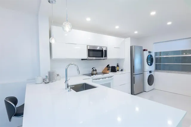 a large bedroom with a bed and a flat screen tv