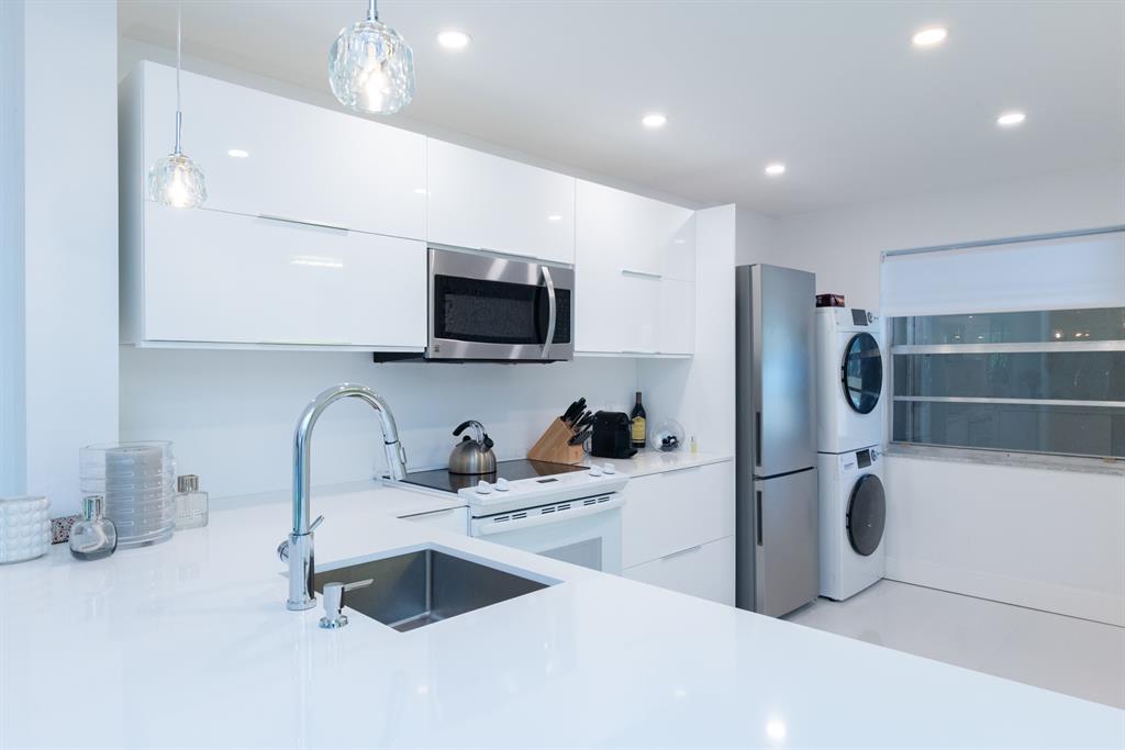 3581 South Ocean Boulevard, Unit 2B Palm Beach, FL 33480 - Photo 16 of 41 a kitchen with refrigerator a sink and a microwave