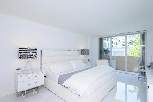 a bedroom with a bed and a night stand