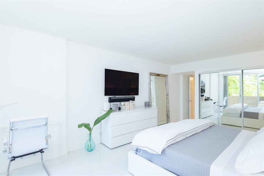 3581 South Ocean Boulevard, Unit 2B Palm Beach, FL 33480 - Photo 19 of 41 a bedroom with a bed and a flat screen tv