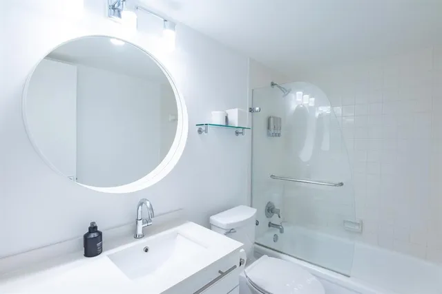 a bathroom with a sink toilet and shower