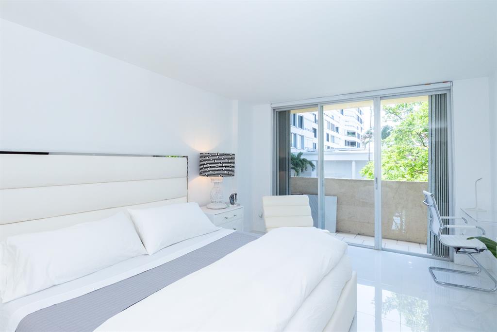 3581 South Ocean Boulevard, Unit 2B Palm Beach, FL 33480 - Photo 21 of 41 a bedroom with a large bed and a large window