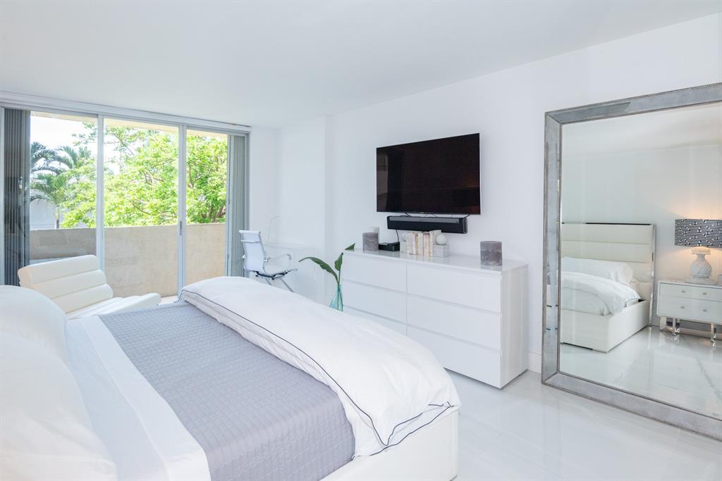 3581 South Ocean Boulevard, Unit 2B Palm Beach, FL 33480 - Photo 22 of 41 a bedroom with a bed and a flat screen tv