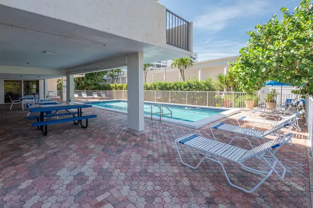a view of house with backyard and outdoor seating