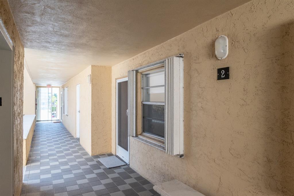 3581 South Ocean Boulevard, Unit 2B Palm Beach, FL 33480 - Photo 30 of 41 a view of a hallway with wooden floor and glass door