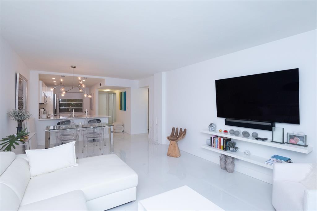 3581 South Ocean Boulevard, Unit 2B Palm Beach, FL 33480 - Photo 4 of 41 a living room with furniture and a flat screen tv